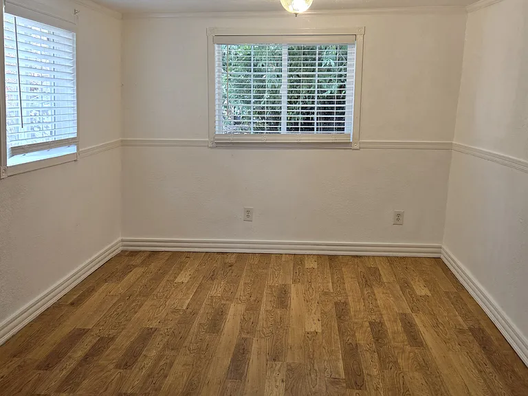 large master bedroom. air conditioner goes in the right window shown. 
100 year old cedar trees shade the house