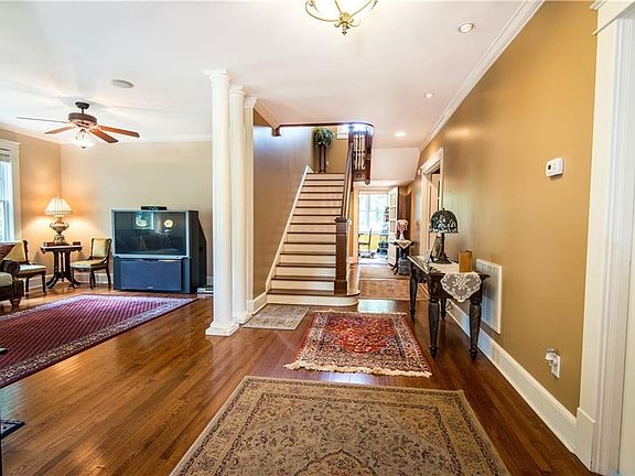 Entering home with beautiful views of hardwoods  and architectural design