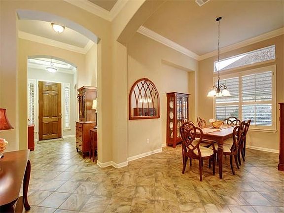 The foyer entry opens to the elegant formal dining room.