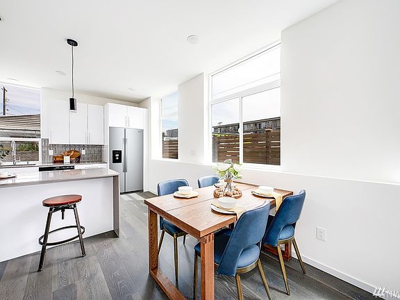 The kitchen has a large bar space for up to 4 stools, plus there's room for a dining table.