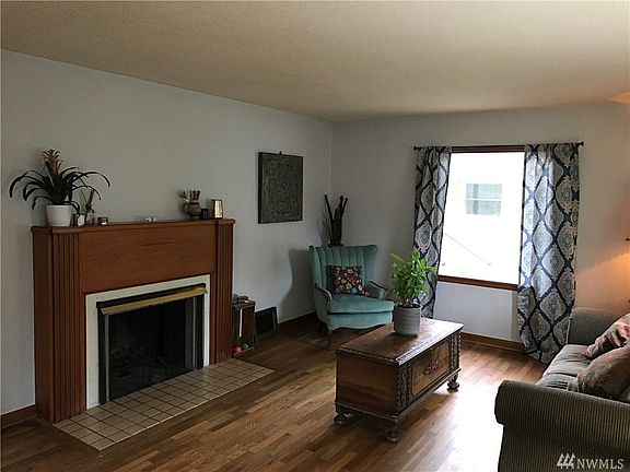 Living room with hardwood floors and fireplace.