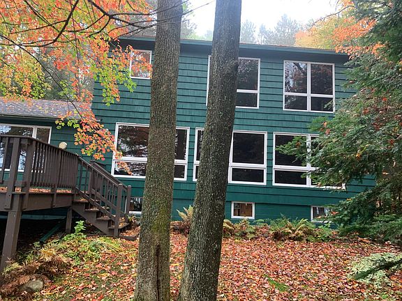 Lake side view of upper primary bedroom, main floor living room and finished basement