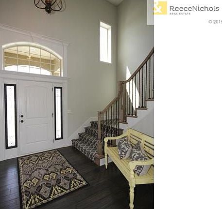 Open entrance with tall ceilings and curved staircase!