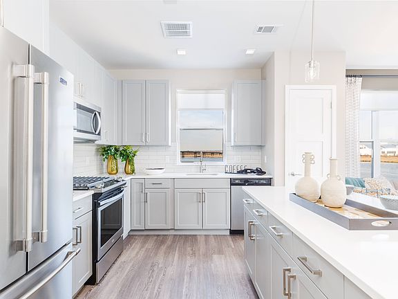 Modern Kitchen Including Quartz Countertops, Designer Tile Backsplashes & Stainless Steel Appliances including Gas Range