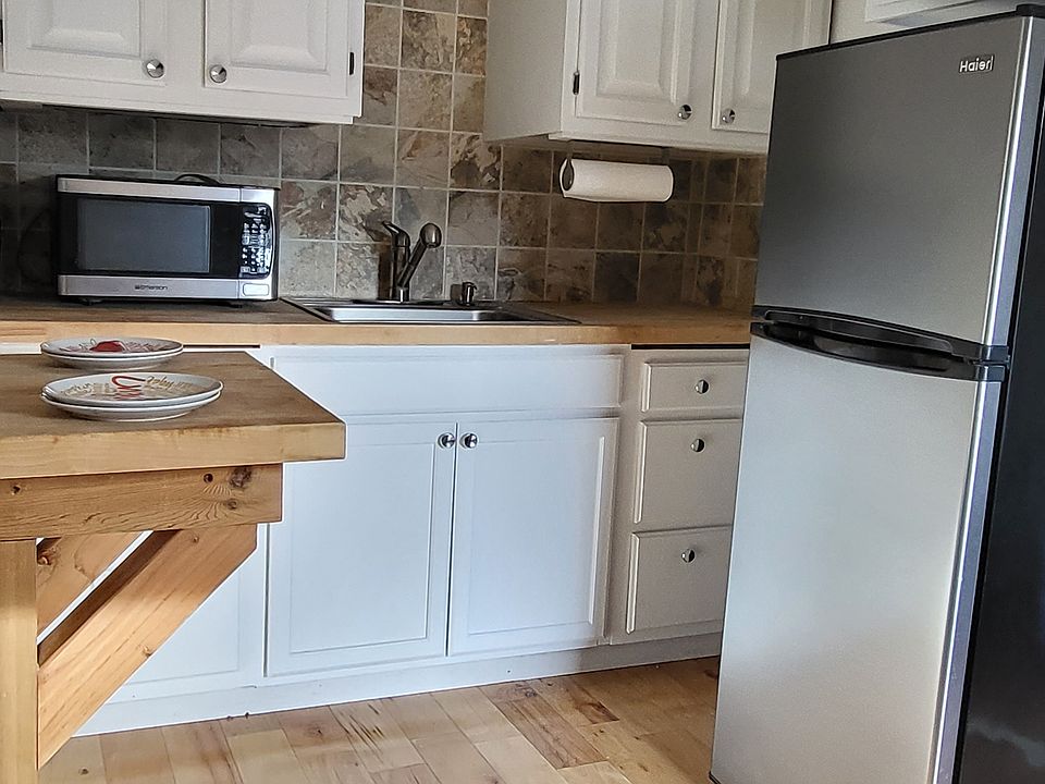 Kitchen view with built in breakfast nook. Seats 1-2 stools.