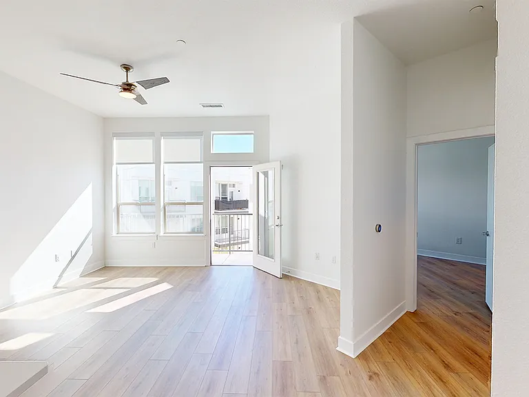 Apartment living room with wood-style flooring.