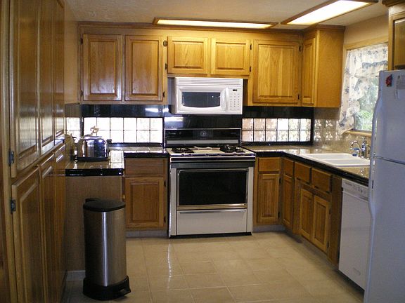Kitchen, glass block windows, floor to ceiling- 6ft. pantry, granite tile.