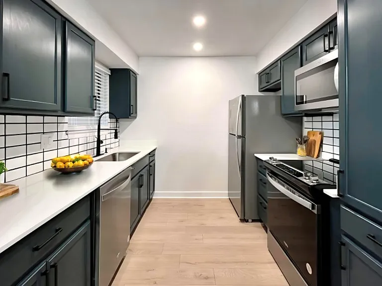 Quartz counters and subway tile backsplash in our renovated units!