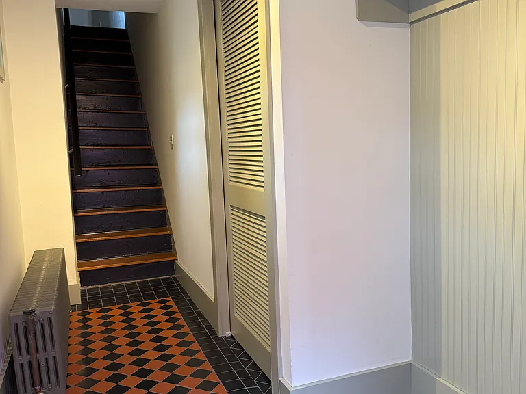 Foyer with washer and dryer (behind pocket door)