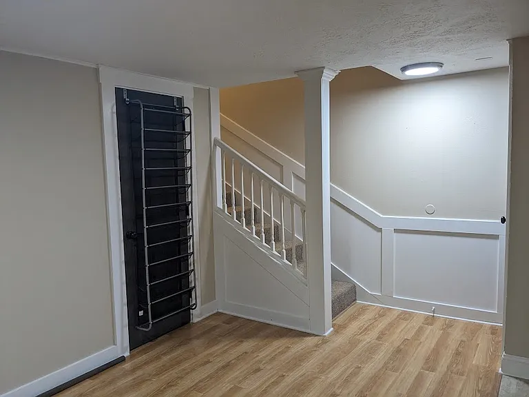 Door to downstairs bedroom and stair landing.