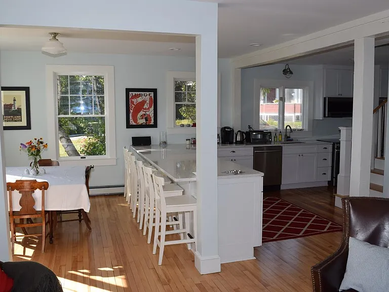 View of kitchen and dining room. Counter height bar seats 6
