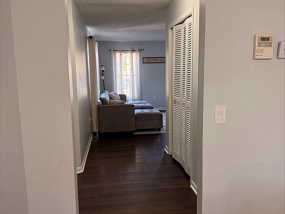 View of front hallway/foyer from den looking into living room.