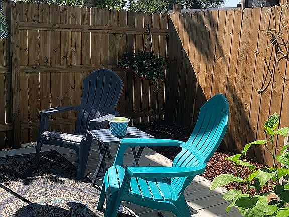 Fenced backyard with deck