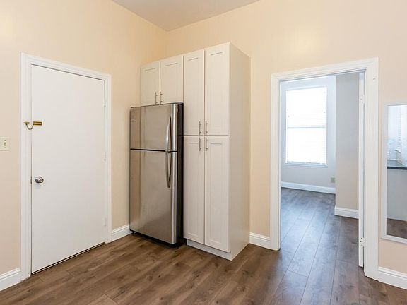 Part of the kitchen. Door leading to Common space. Washer/dryer one flight of stairs down.