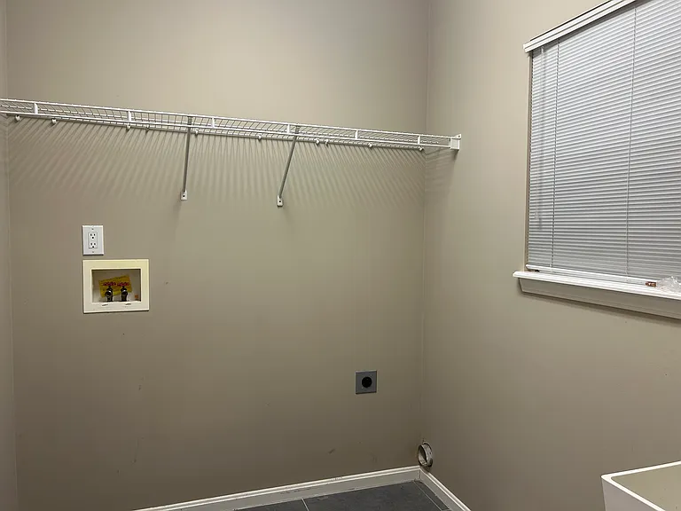 Tiled Laundry room with Utility sink and built-in Ironing board