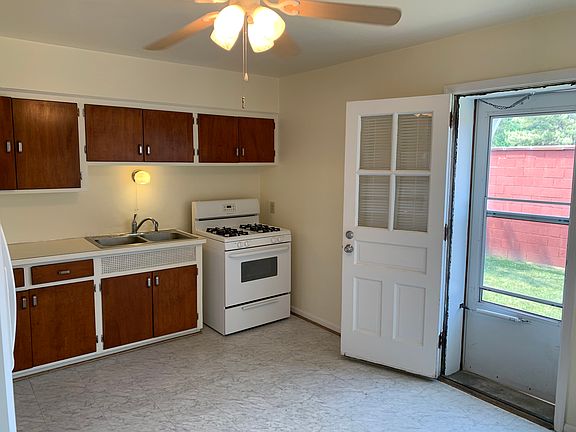 Kitchen, gas range, sink and cabinets.