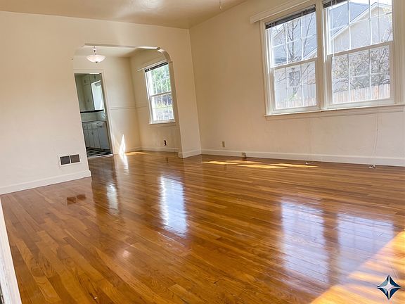 Living Room and a peek of the dining room. Note the newly refinished solid oak floors.
