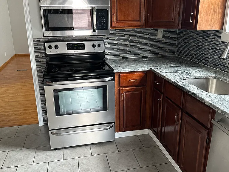 Kitchen, stainless steel appliances, granite countertops, newly stained cabinets