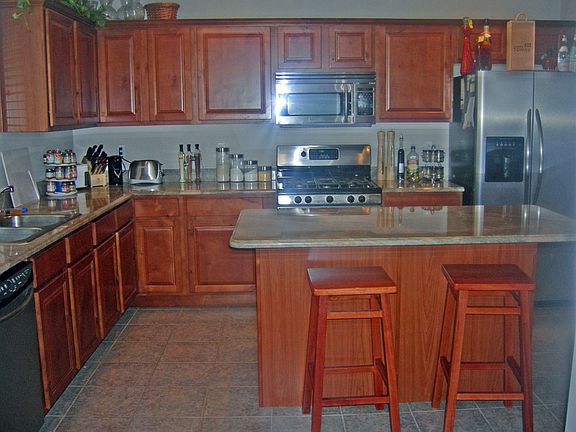 Kitchen-all stainless steel appliances and knotty alder cabinets