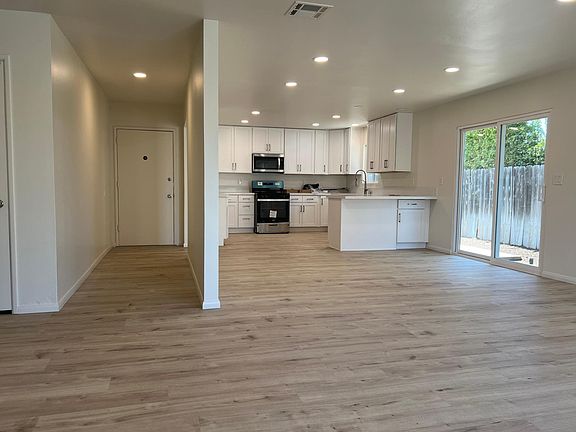 Looking back at entrance and kitchen from living room