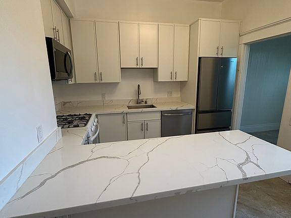 Newly renovated kitchen with all new appliances and cabinets; includes dishwasher, garbage disposal, and microwave