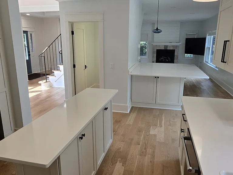 Kitchen with view of dining room, guest bathroom and living area showing gas fire place and large screen TC