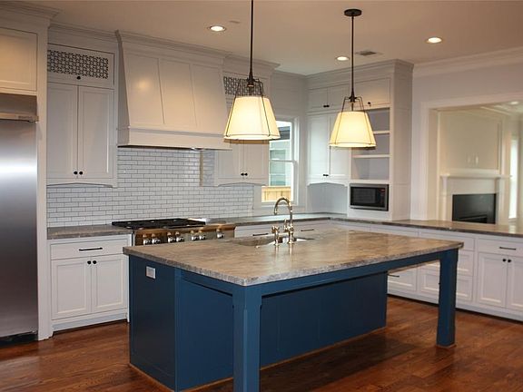 This oversized kitchen offers a great layout, access to butler station to dining room, oversized island with quartzite counter and designer color "pop" , 42" fridge, 48" range.
