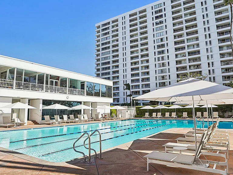 Heated Jr. Olympic size pool with plenty of seating and umbrellas