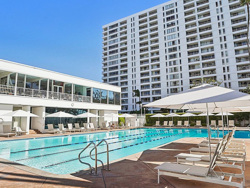 Heated Jr. Olympic size pool with plenty of seating and umbrellas