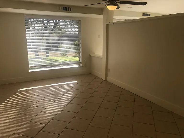 bedroom with a view of the back yard and patio