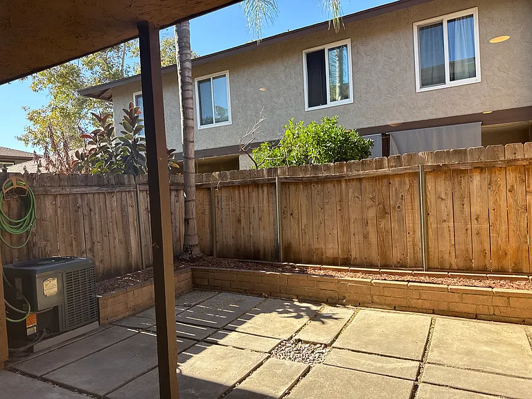 Spacious paved patio with brand new washer dryer in storage closet