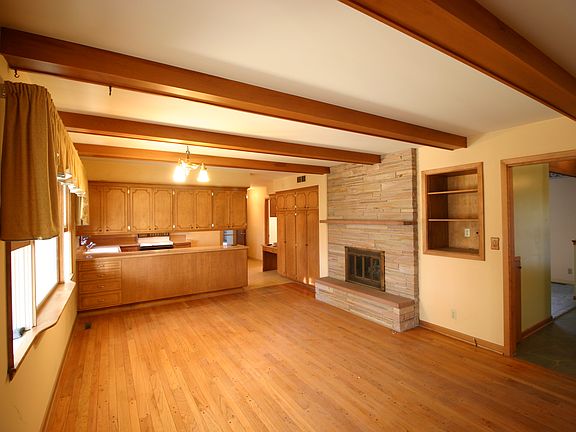 Dining area w fireplace, Kitchen in background