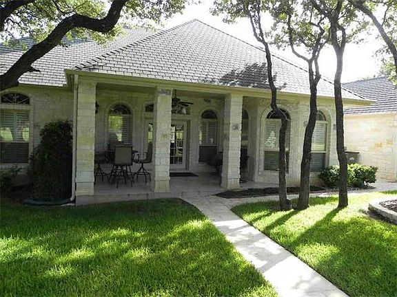 Mature trees surround the covered back patio