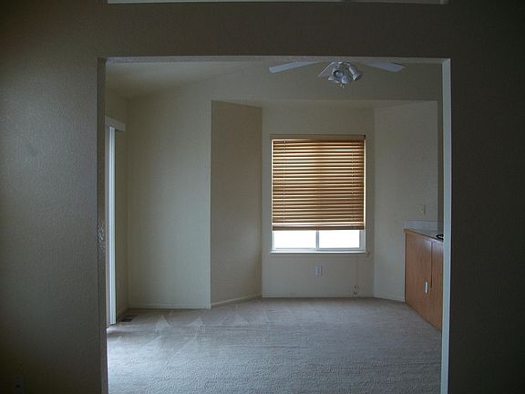 Dining area with sliding door to small deck and fenced backy