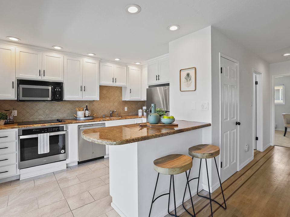 Updated kitchen with stainless steel appliances and recessed lights.