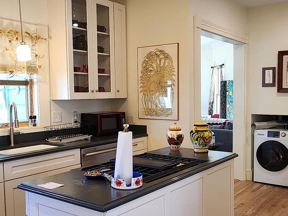 Kitchen With Counter Mount Stove, Washer And Dryer, Hardwood Flooring