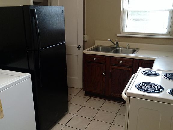 Kitchen with appliances, including washer, dryer, and refrigerator