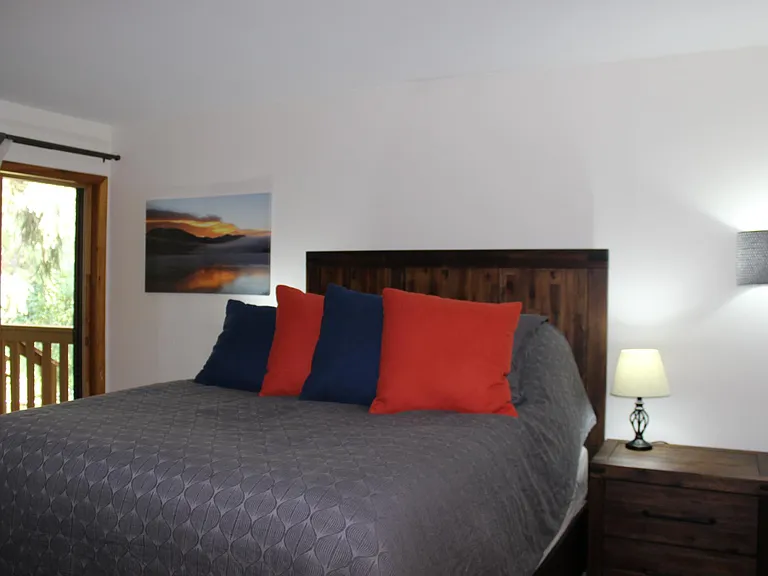 Master bedroom. Full-size closet in the room and a dresser with a TV.