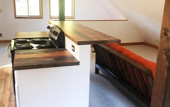 Kitchen bar, stove, and cooking space.