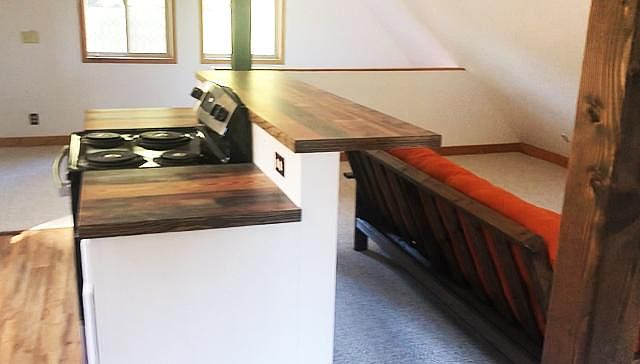 Kitchen bar, stove, and cooking space.