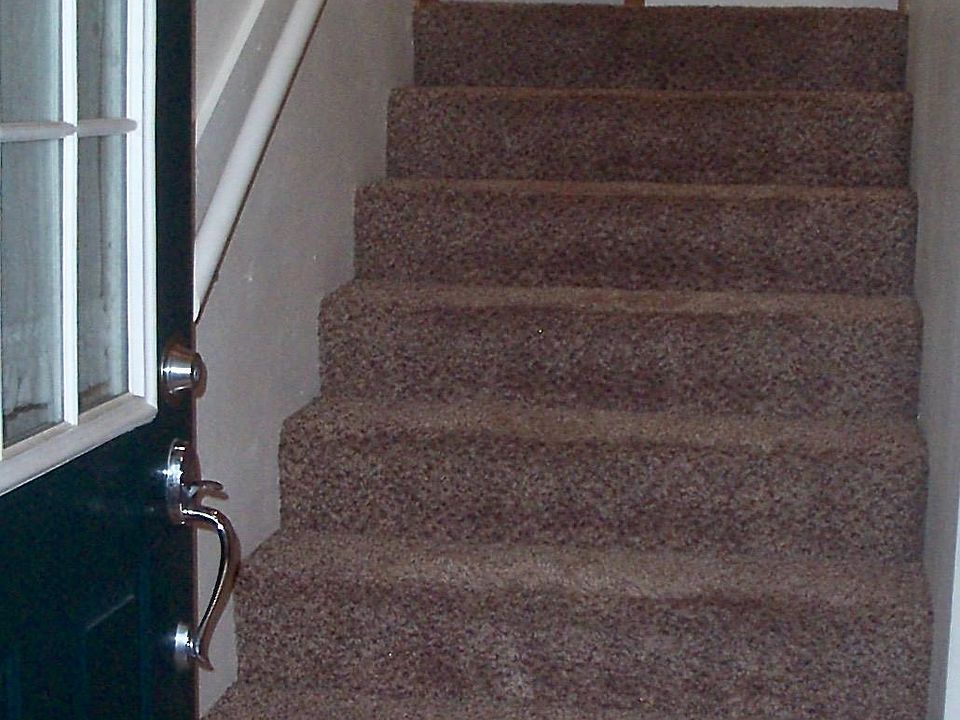 To the upper level: Livingroom, kitchen, and guest bathroom. Two large coat closets at top of stairs.