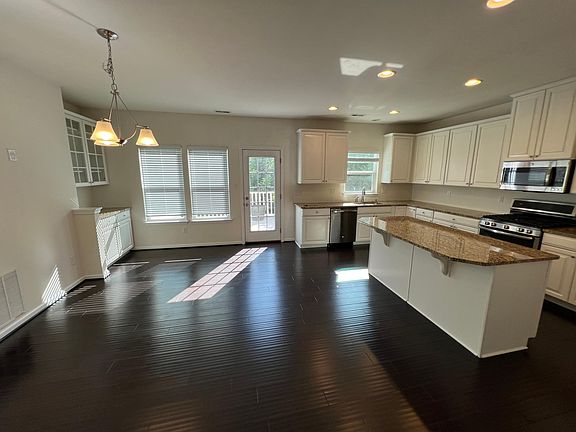 Dining room and kitchen with door to deck