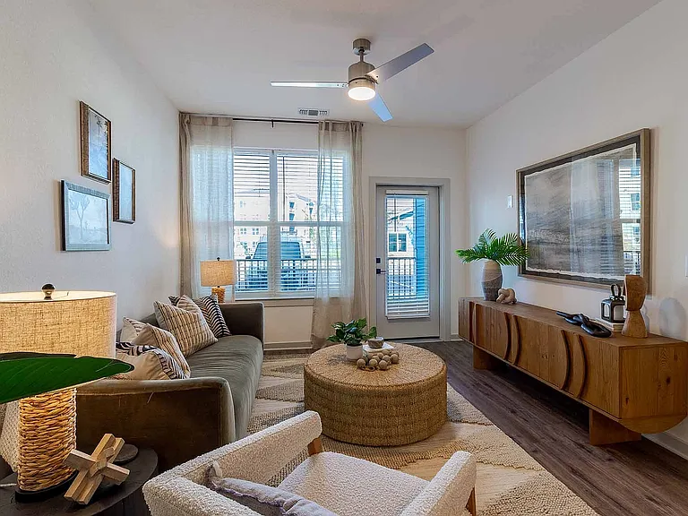 Spacious and move-in ready, the living area offers room to lounge and entertain, with a ceiling fan and wood-style plank flooring throughout.