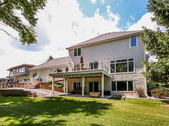 Fully fenced in backyard w/ maint. free deck w/ a catwalk to both rear patios.