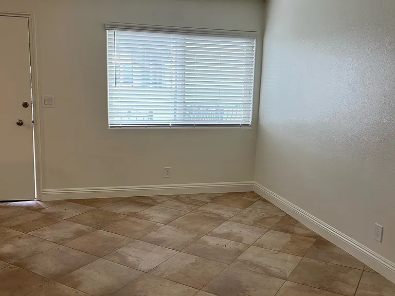 Living Room with new blinds, new paint and large window for daylight