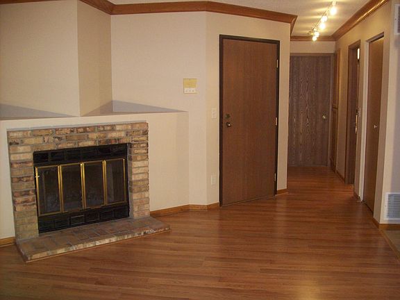 Hallway to coat closet, bathroom, linen closet and bedroom at the end.