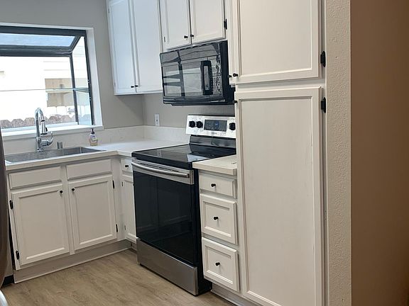 Kitchen also features microwave and flat surface range oven, and plenty of cabinet space.