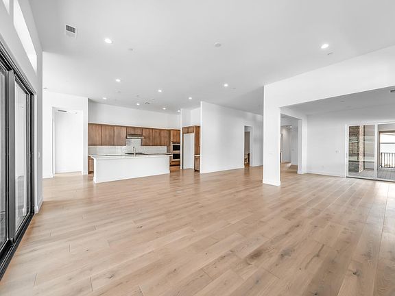 Spacious great room with a multi-sliding glass door and open space to entertain