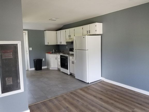 Open great room style. Living room looking into the kitchen. New flooring and all fresh paint.