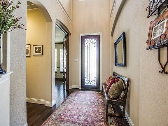 The bright open foyer leads to a private study with french doors.